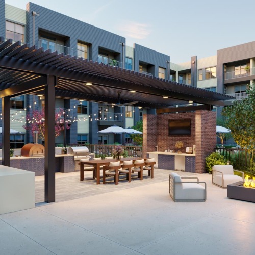 a courtyard with tables and chairs and umbrellas and buildings in the background