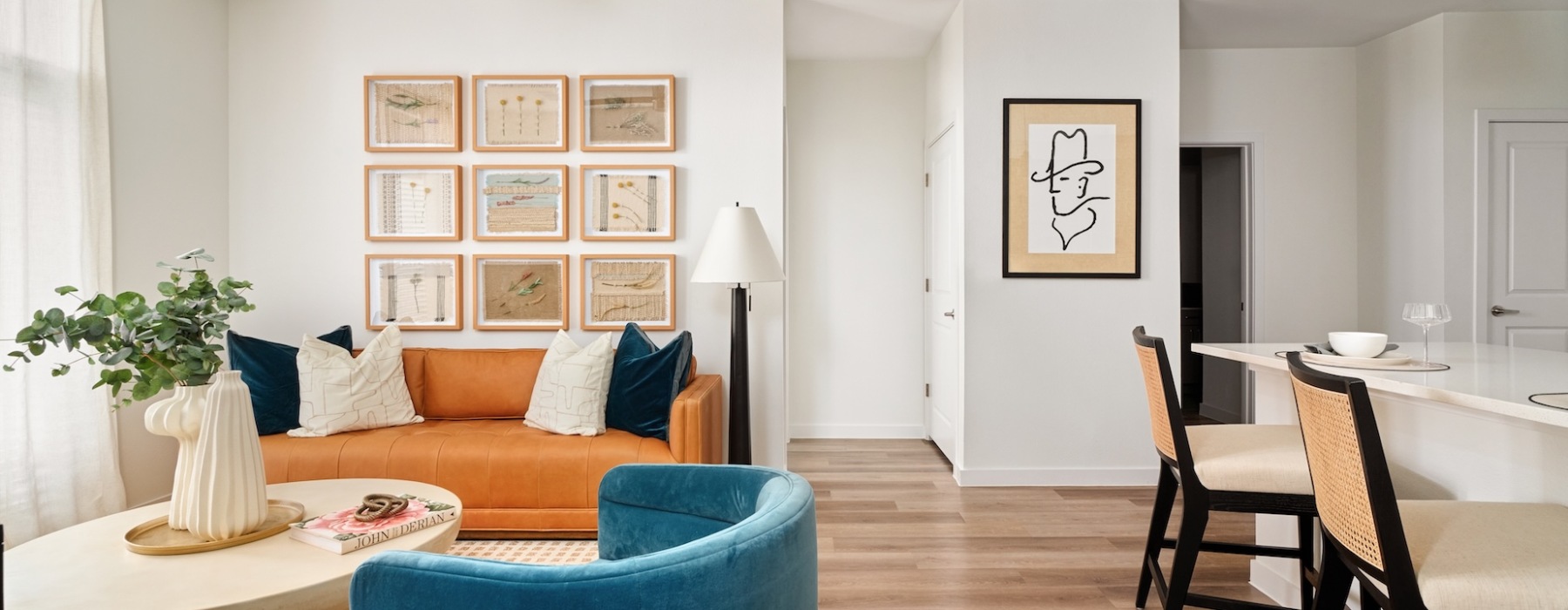 kitchen open to well lit living room with ample seating