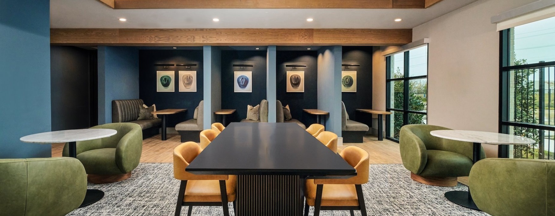 open room with tables chairs and booth meant for remote work