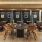 a room with a table chairs and windows