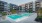 a swimming pool in a courtyard between buildings