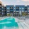a swimming pool in front of a large building