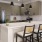 a kitchen with an island and chairs