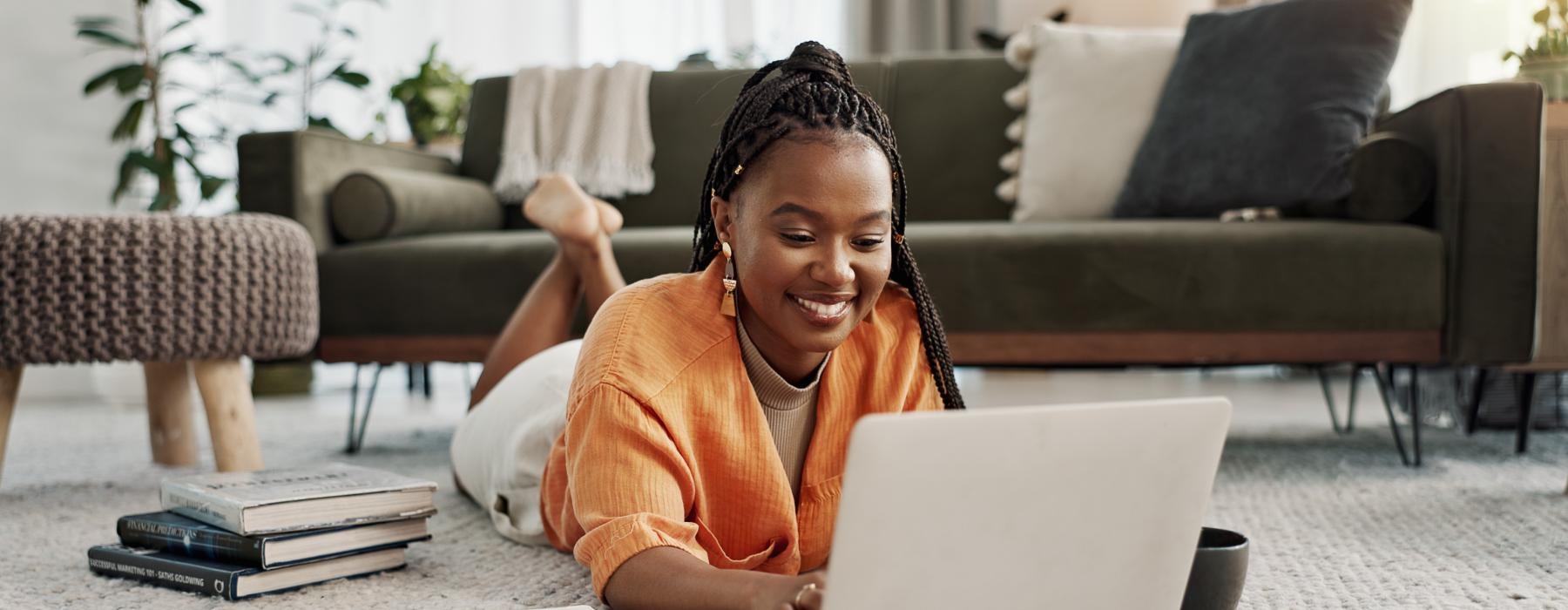 a person sitting on the floor with a laptop