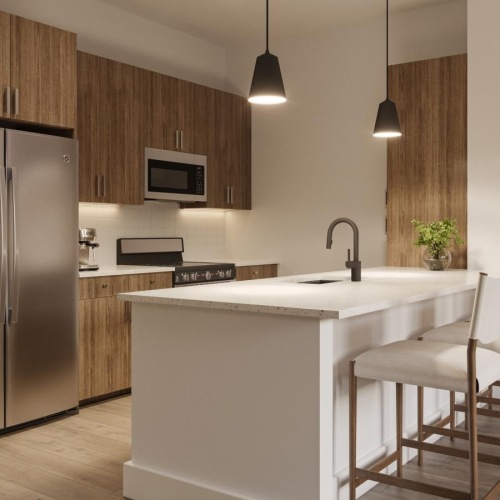 a kitchen with bar stools and a refrigerator